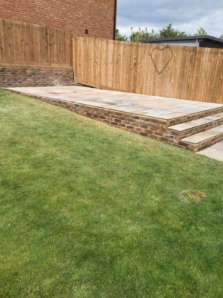 Raised garden paving with brick edging and new lawn