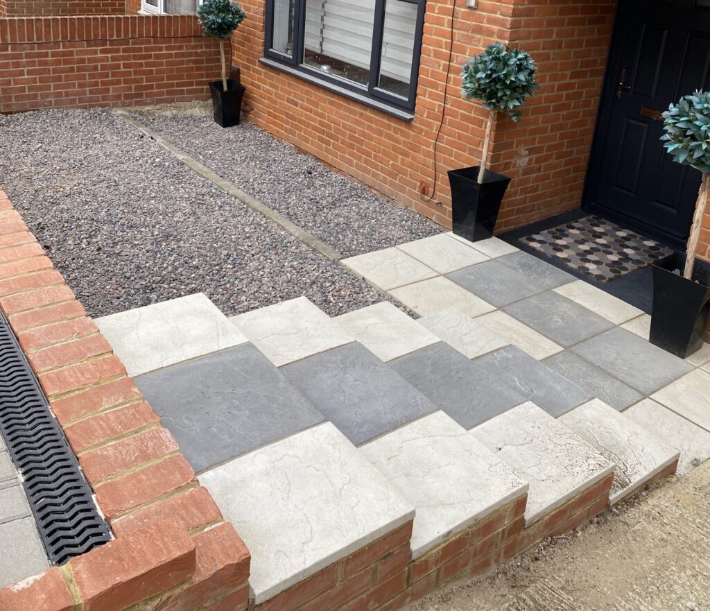 Two-tone concrete paving slabs with brick edging