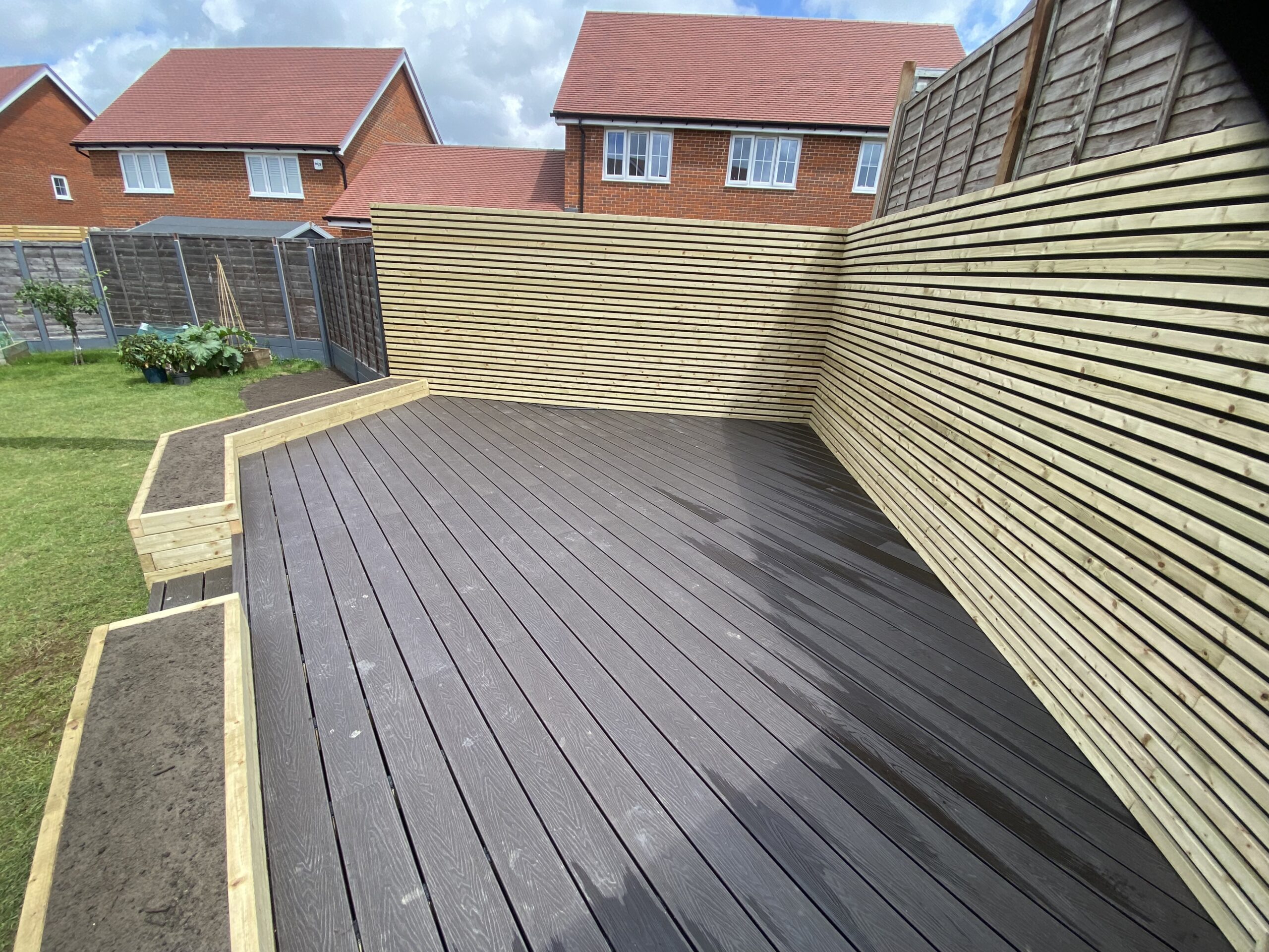 Slatted garden fencing installed along a boundary