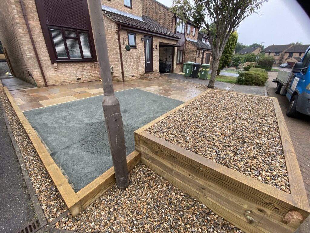 Timber sleeper garden borders with decorative stone