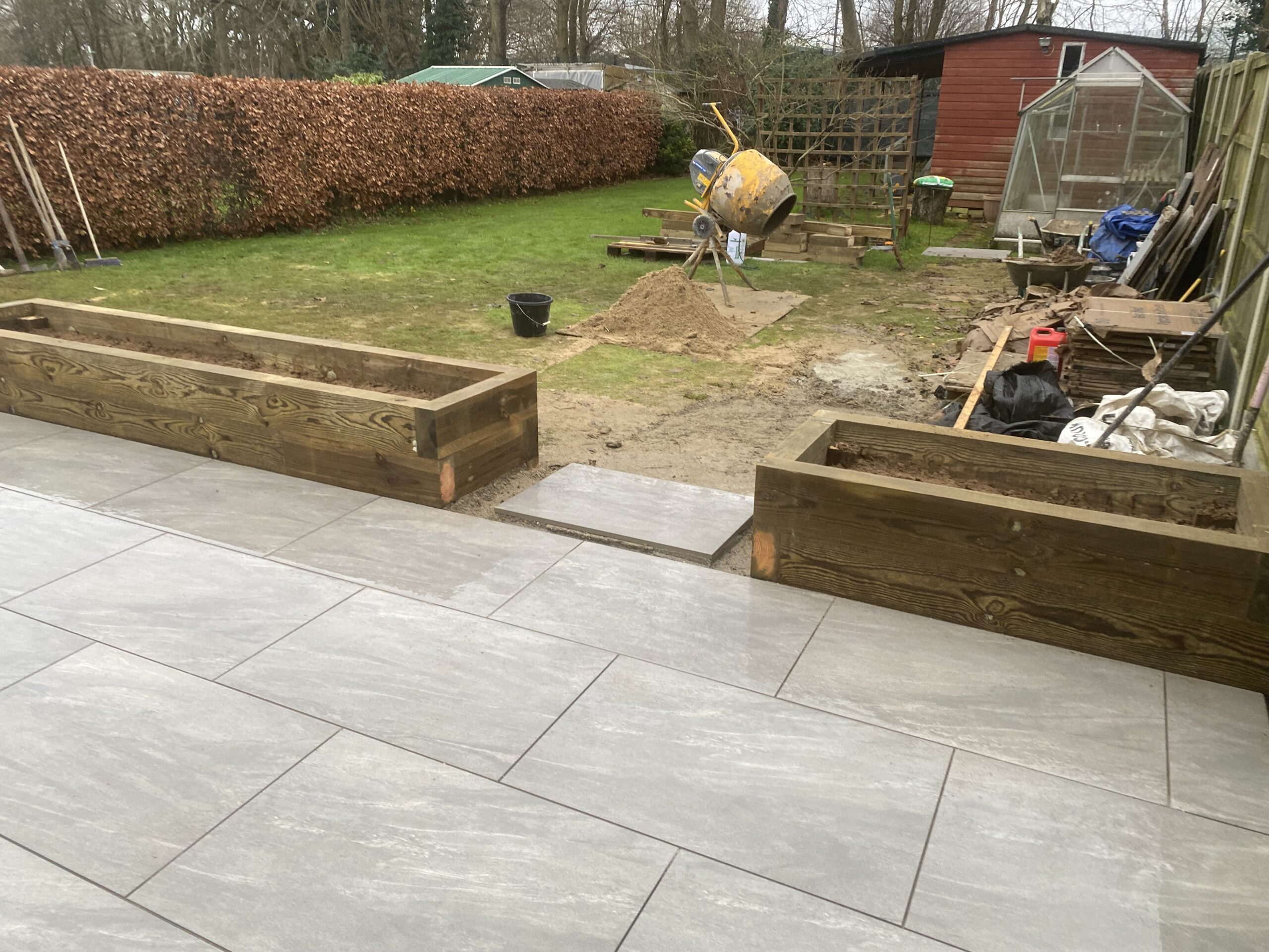 Sleeper raised beds and planters in Maidstone beside a paved patio