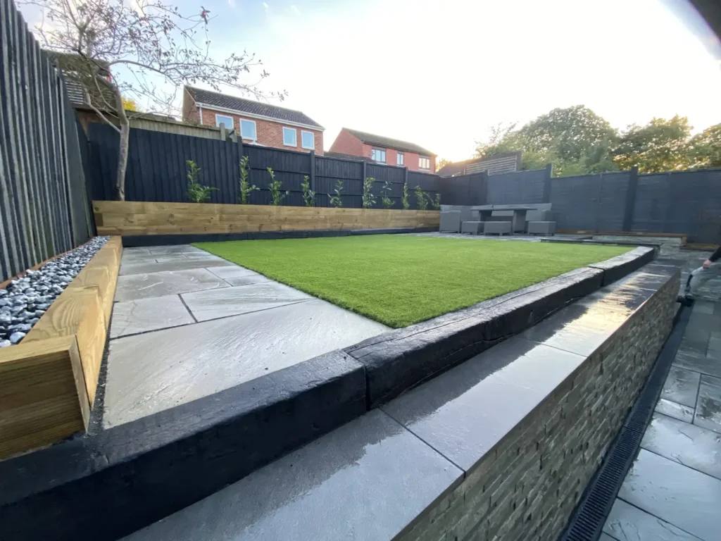 Complete low-maintenance garden with artificial grass, paving and raised planters