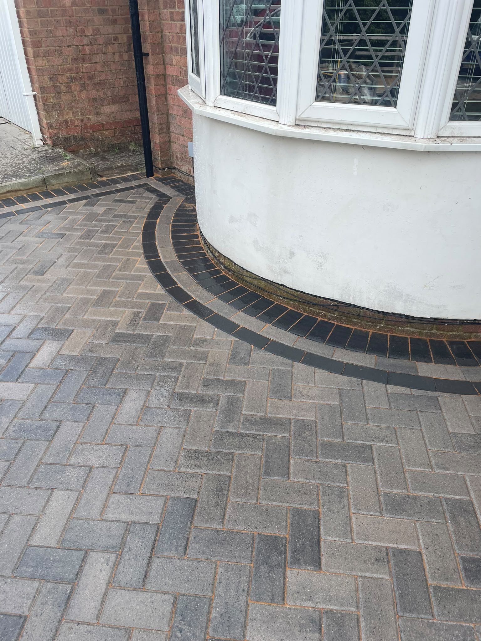 Grey block paving driveway with curved border in Maidstone
