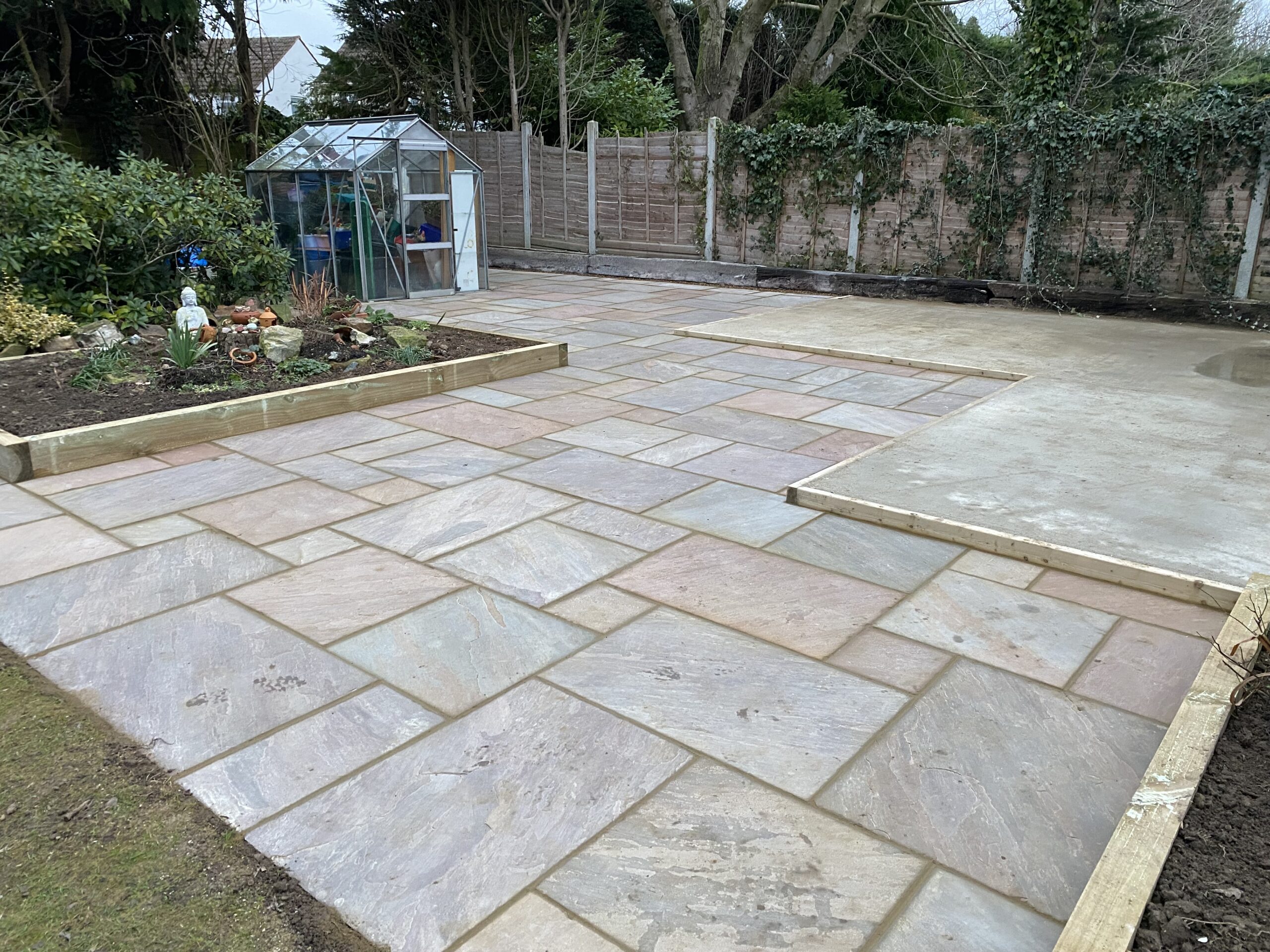 Concrete base beside a newly laid sandstone patio in Maidstone