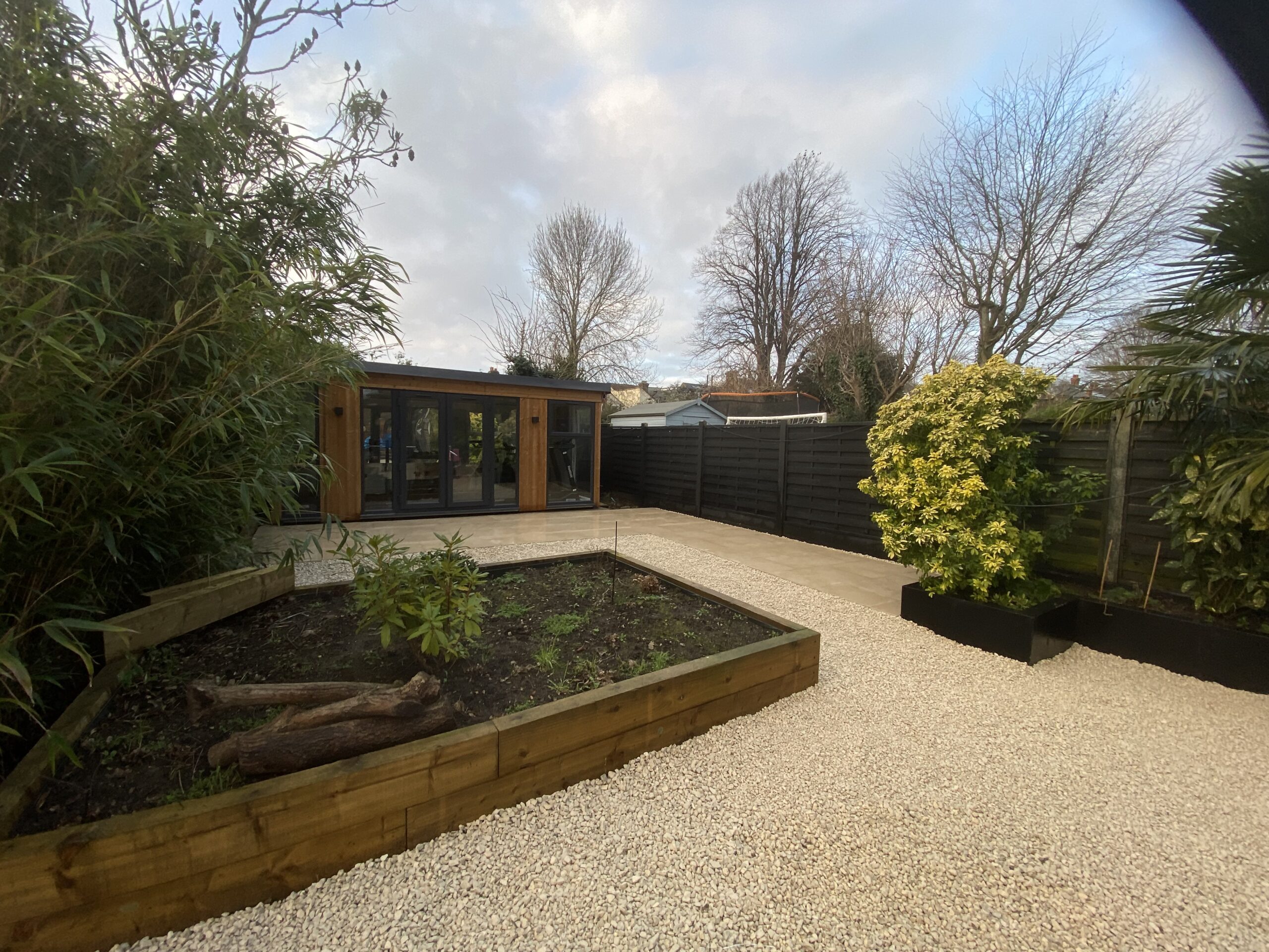 New cots wold stones and porcelain patio with sleeper planter