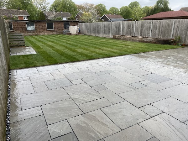 New lawn beside a natural stone paved area