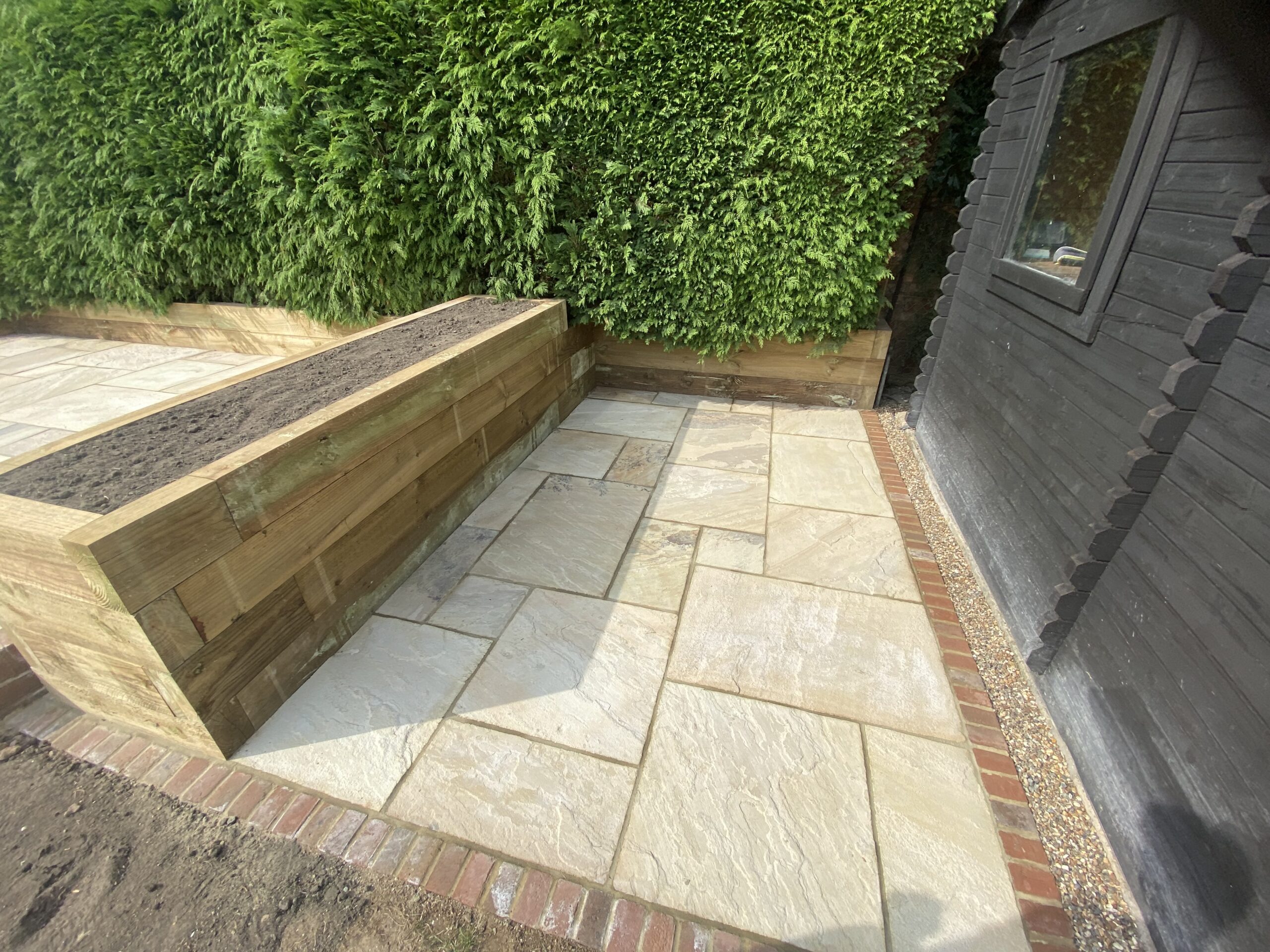 Mint Indian sandstone patio with brick edging